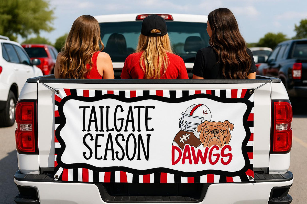 Football tailgate banner with bulldog mascot and red black team spirit decor displayed on a truck tailgate